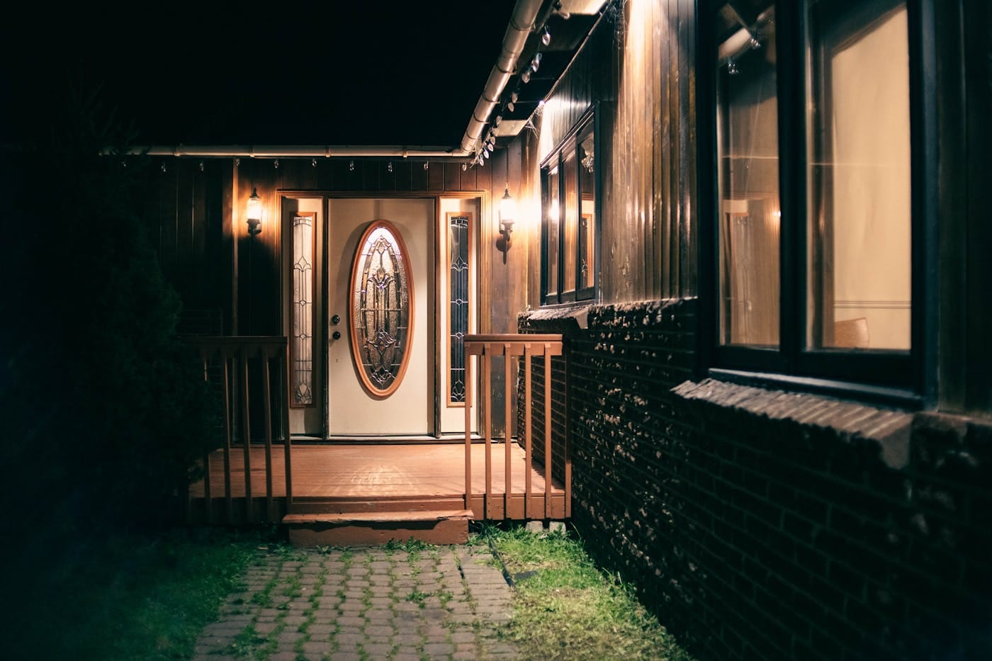 US residential home porch at night with warm entrance light illustrating a home lockout scenario