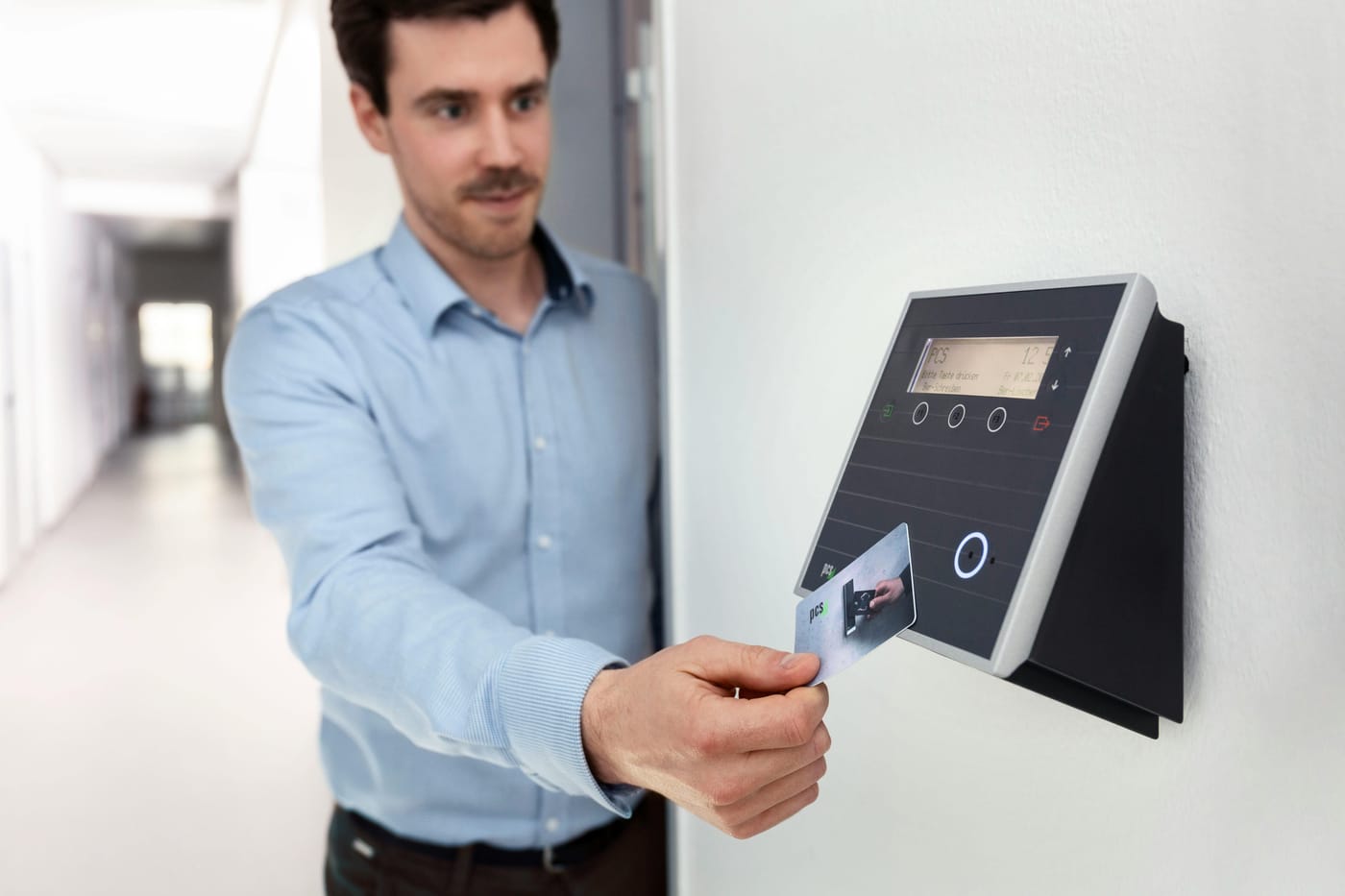 Man presenting a card to an electronic access terminal