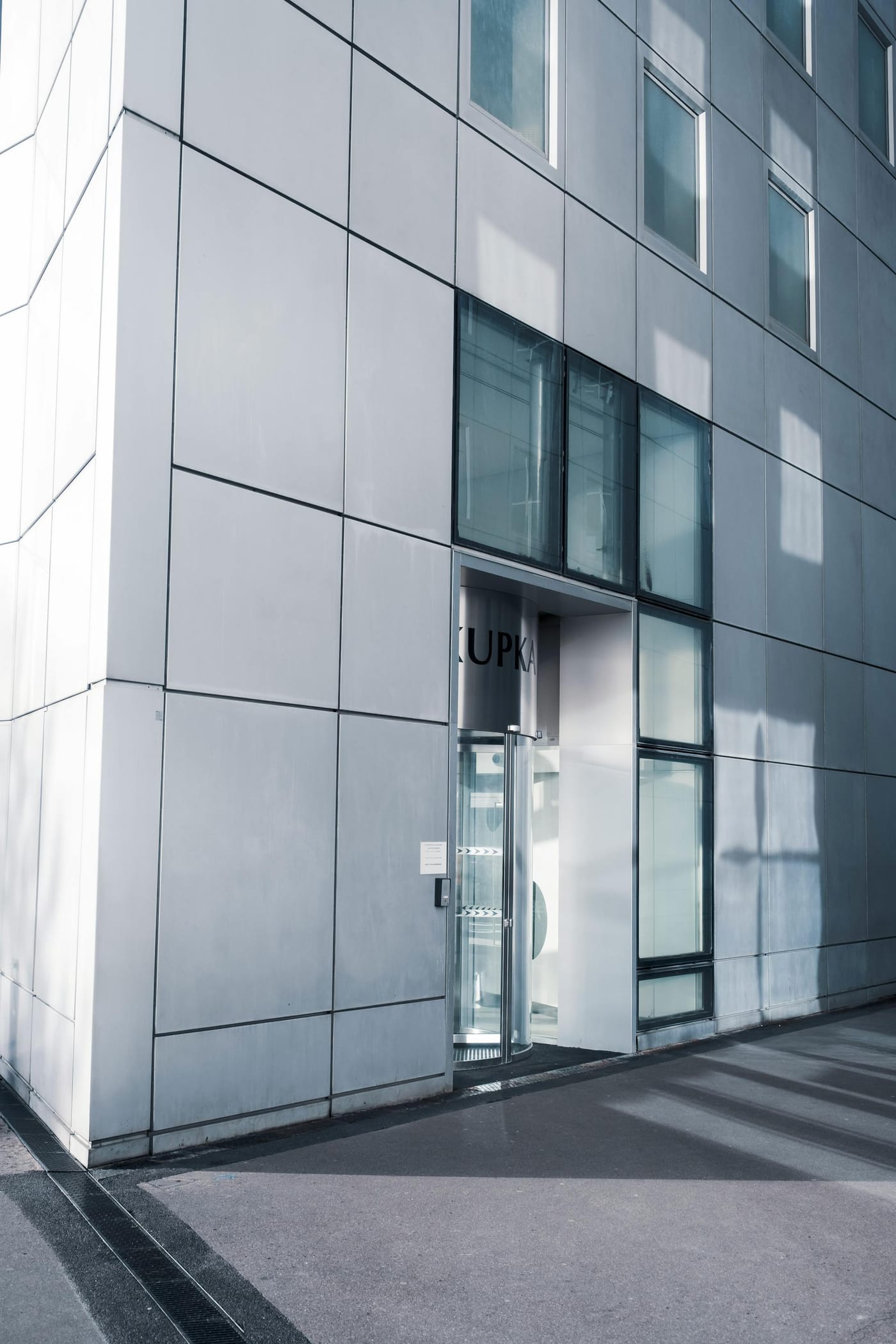 Glass door set into a modern metal-clad building