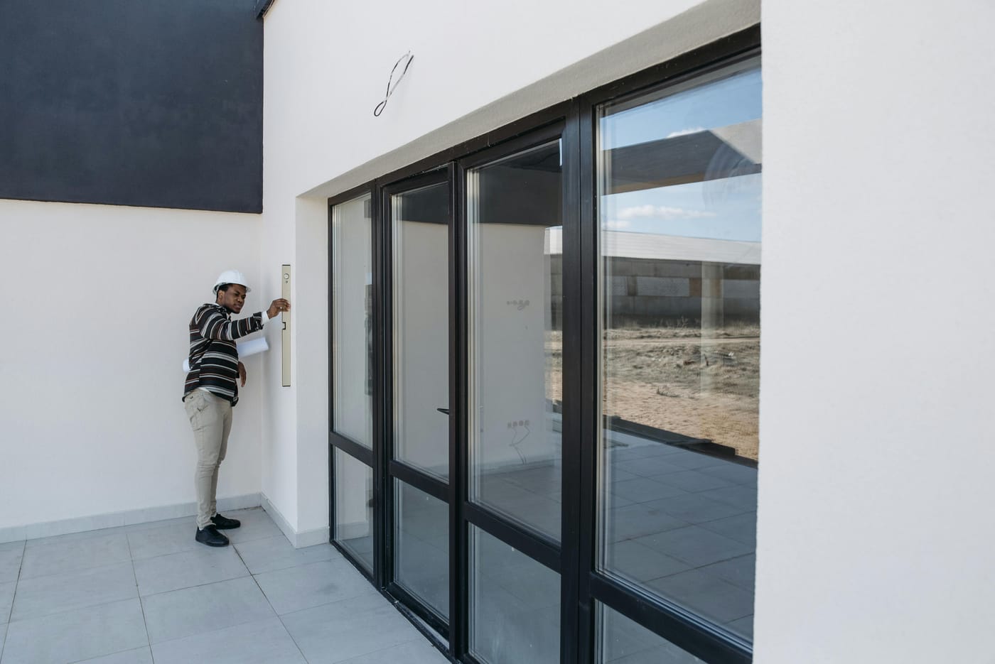 Person working beside a large glass entrance