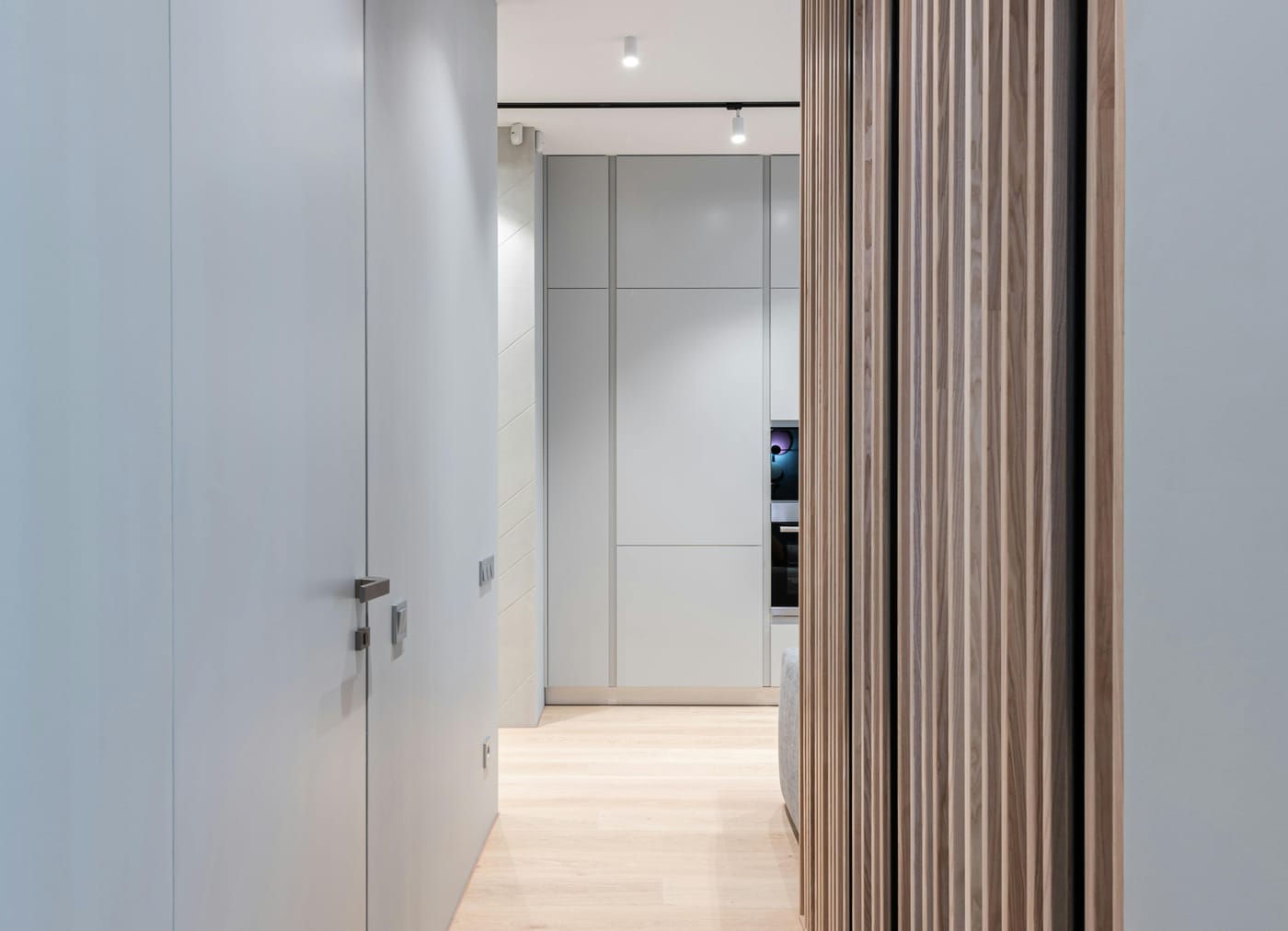 Flush white door beside vertical wood paneling