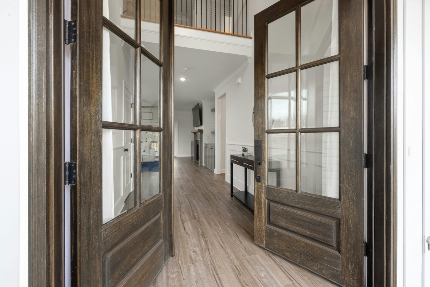 Wooden double doors with glass panes at a home entrance