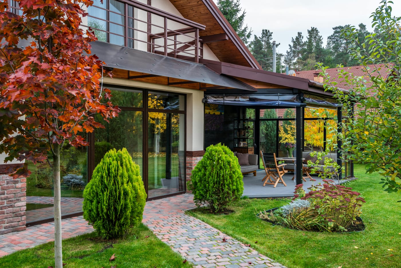 Glass patio enclosure beside a landscaped garden