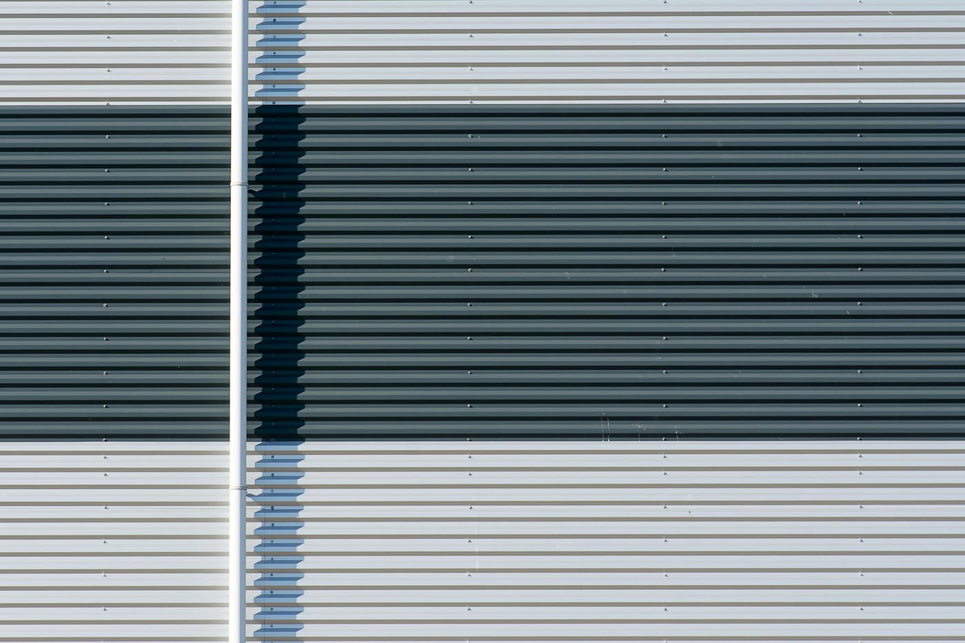 Corrugated metal roll-up door with a dark painted stripe