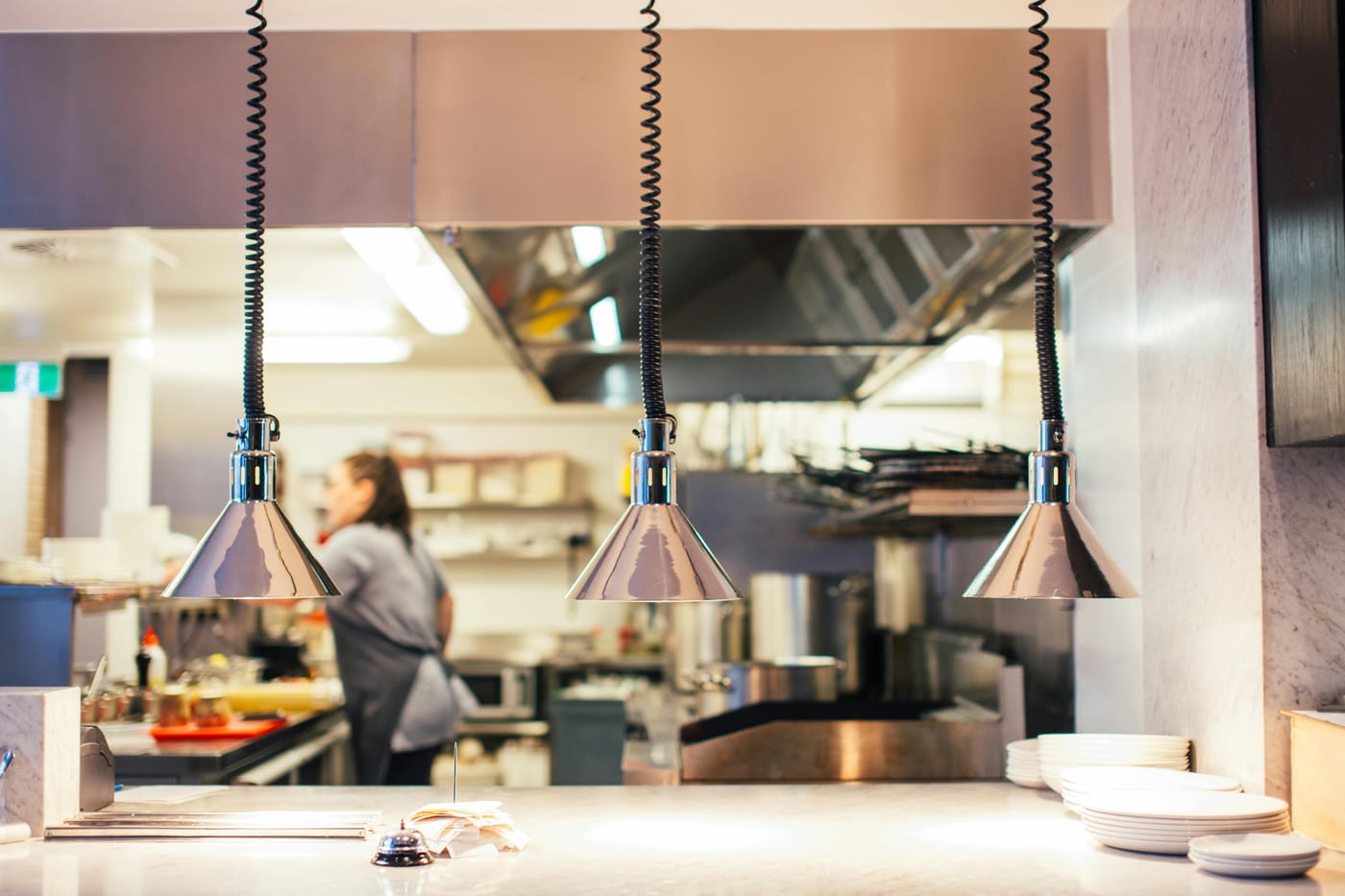 Food preparation counter and heat lamps in a restaurant kitchen
