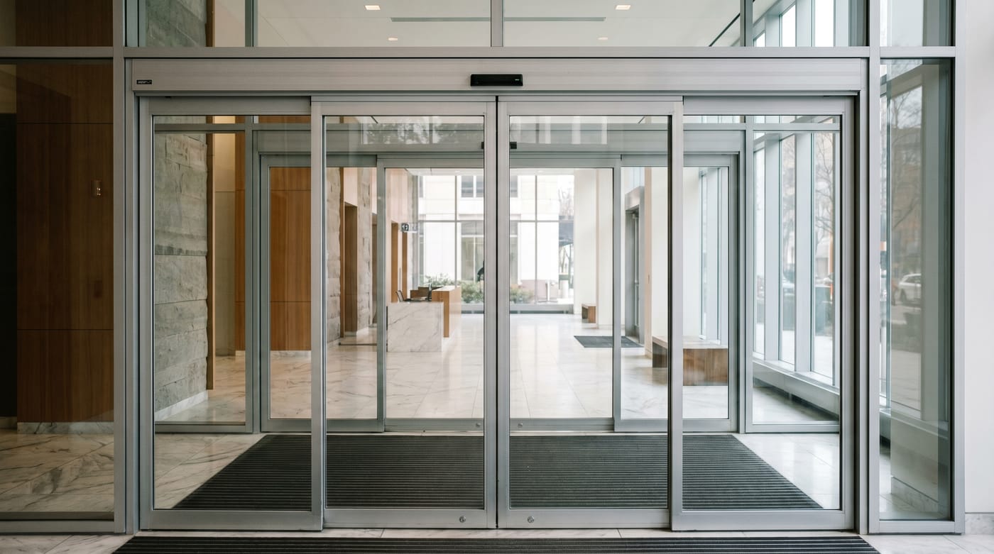 Multiple glass entrance doors in a modern lobby