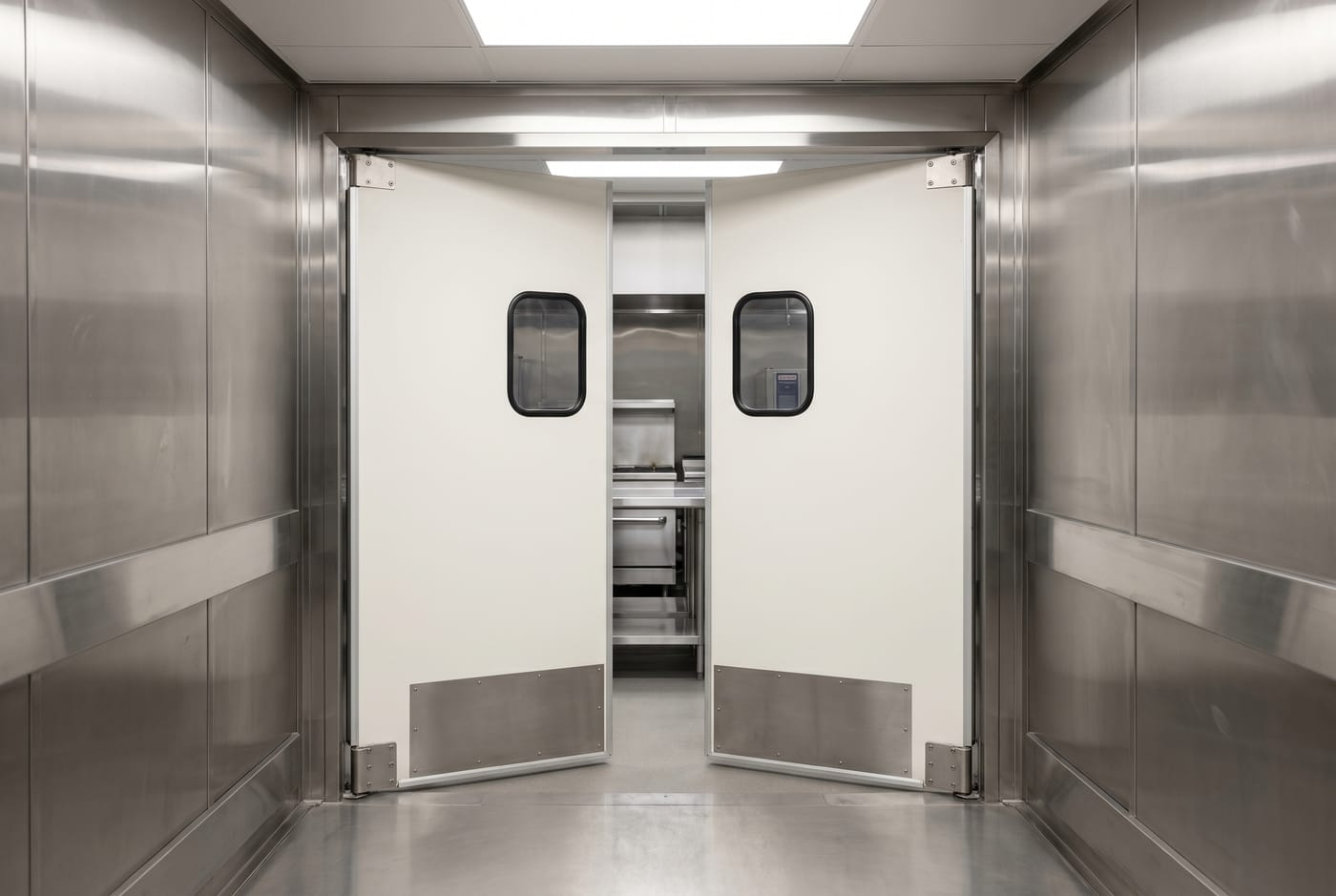 Illustration of double swinging doors with small windows and metal kick plates