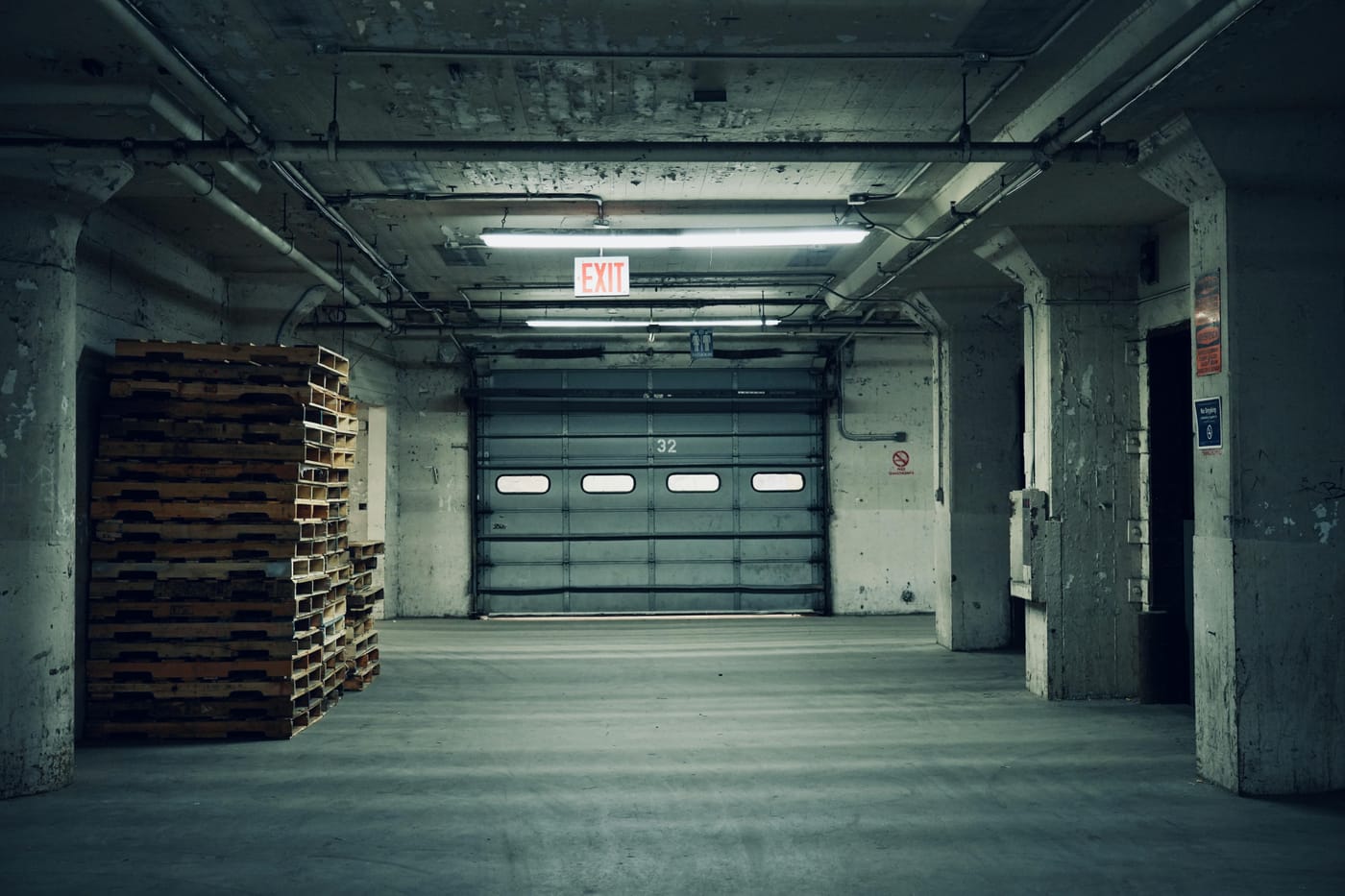 Warehouse interior with pallets and a closed sectional door