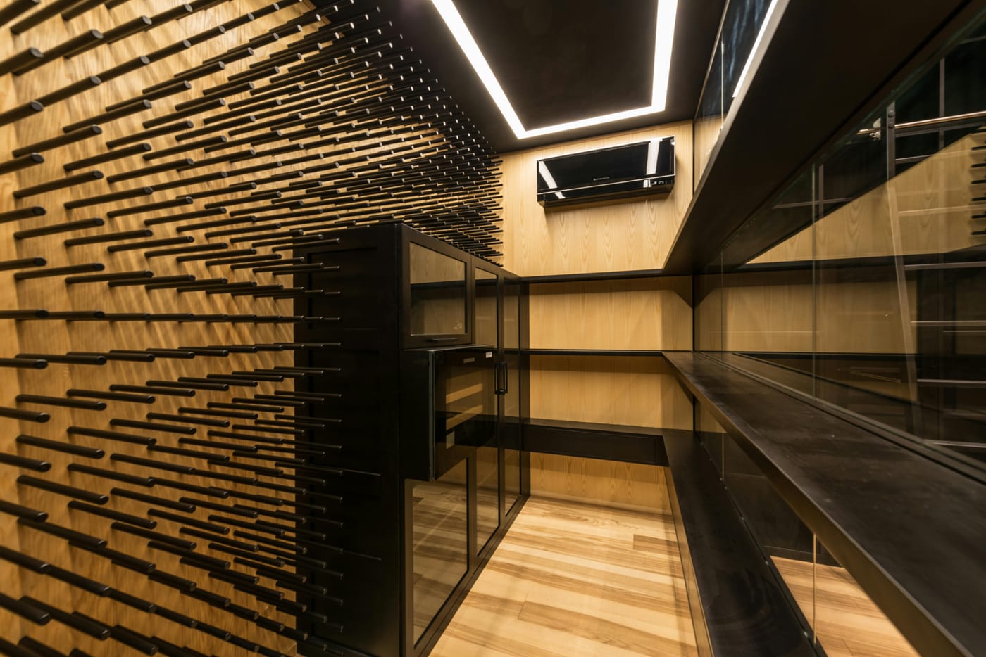Wood-lined wine storage room with empty shelves