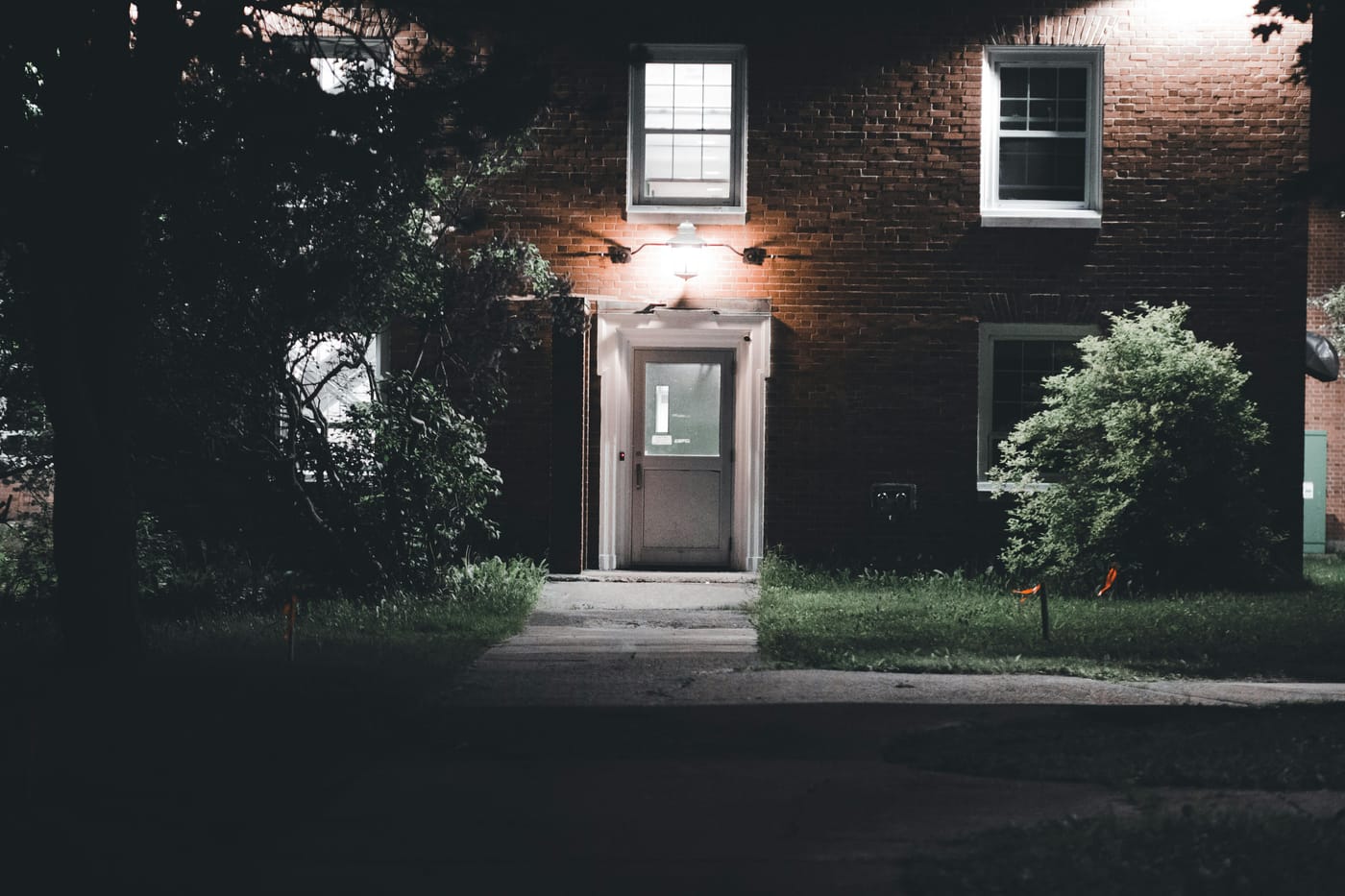 Warmly lit brick house entrance under a night sky in Washington DC for 24-hour emergency locksmith service