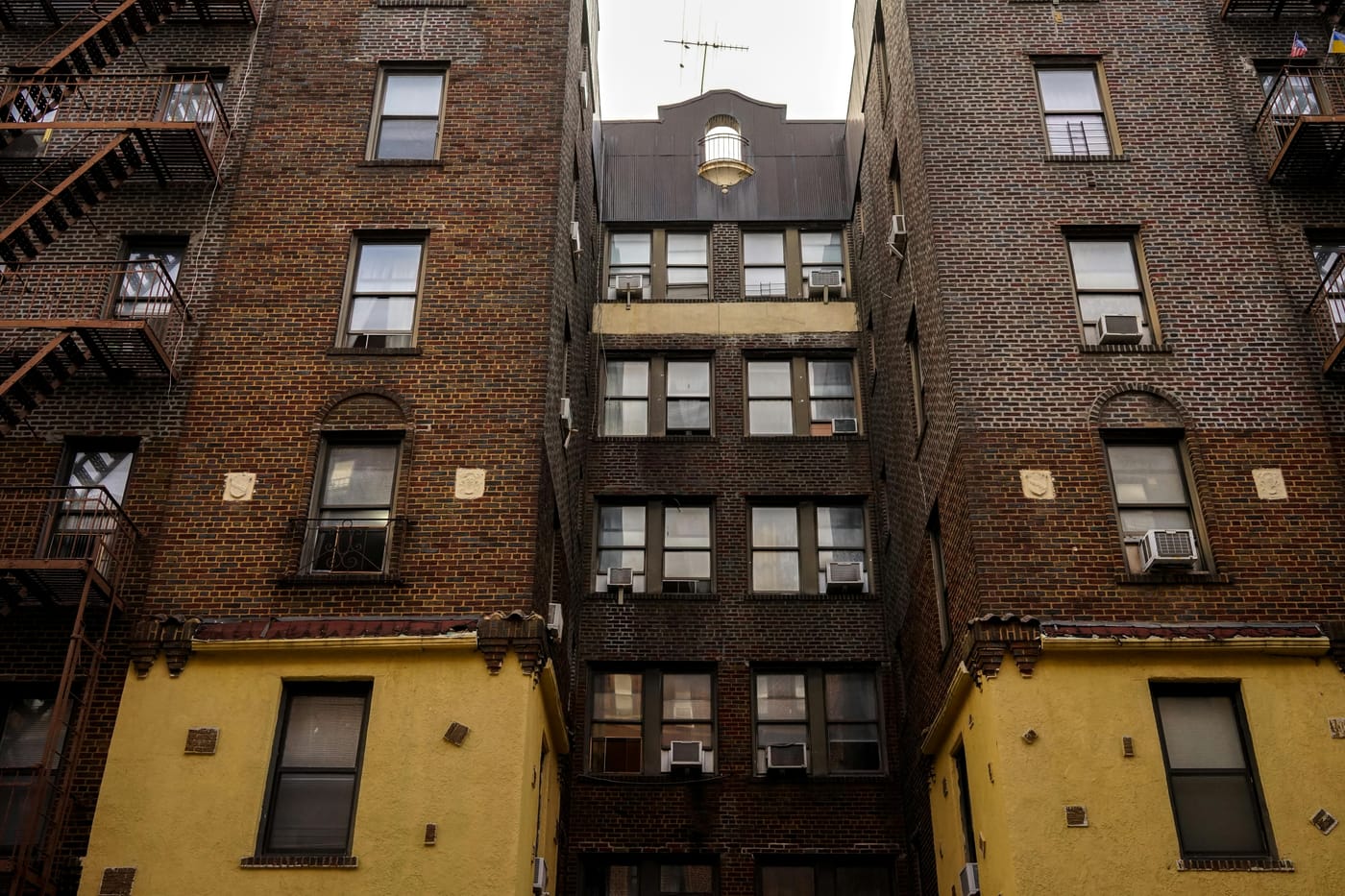 Urban brick apartment building with fire escapes representing Washington DC multi-unit residential locksmith service