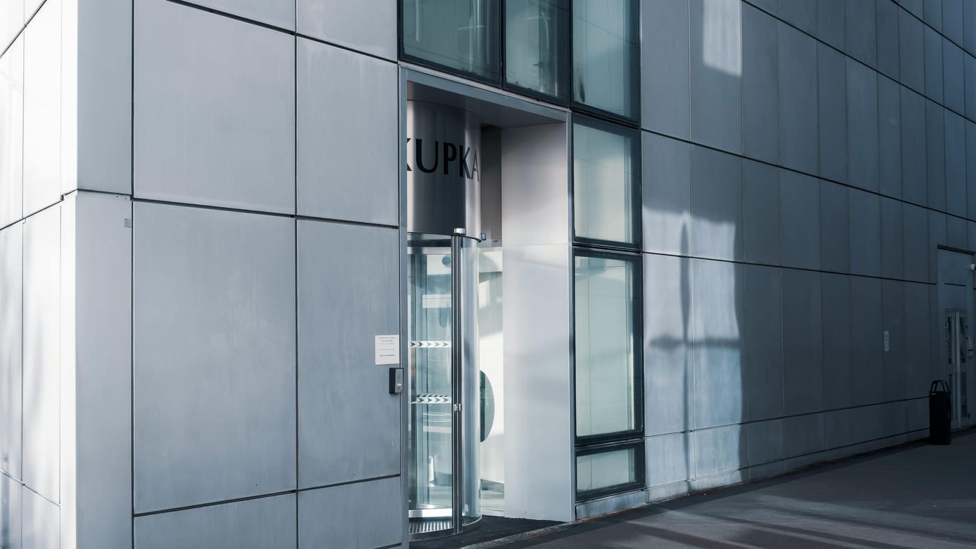 Sleek modern commercial building entrance with glass facade and reflective exterior for business lockout service in Washington DC