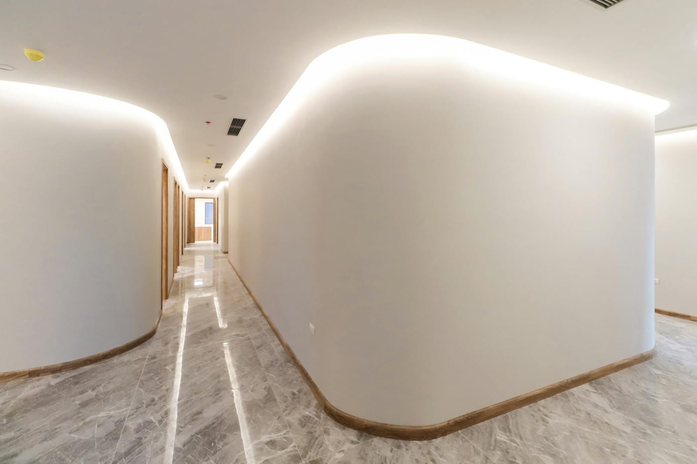 Modern minimalist office hallway with soft recessed lighting representing Washington DC commercial office buildings