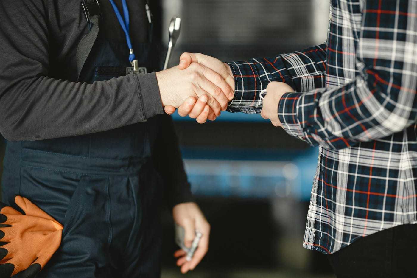 Technician in work uniform shaking hands with customer after completing a locksmith service call in Washington DC