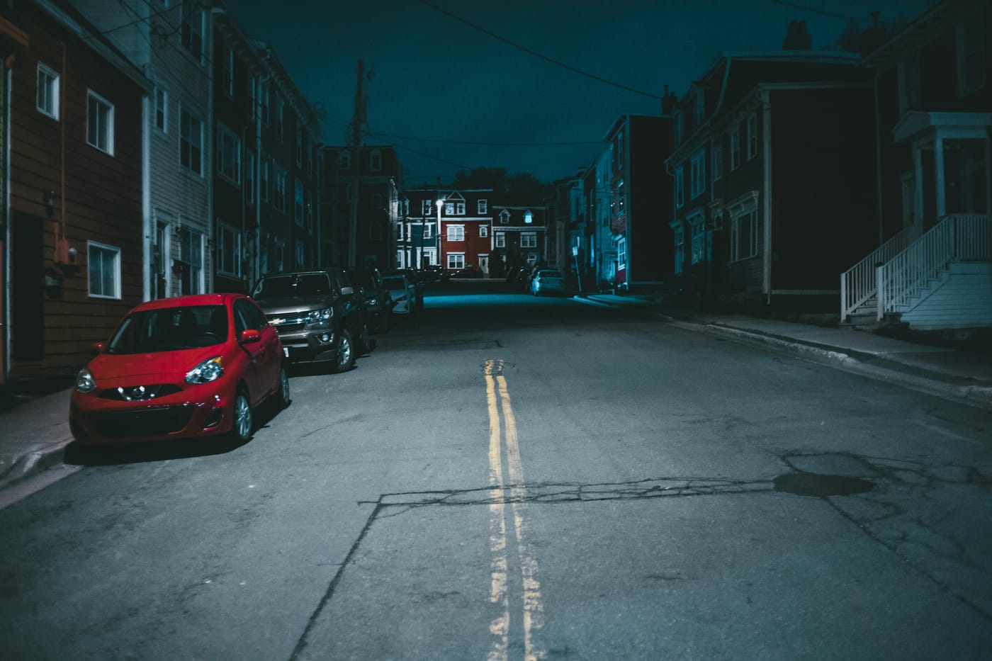 A quiet Washington DC residential street at night, lit by street lamps