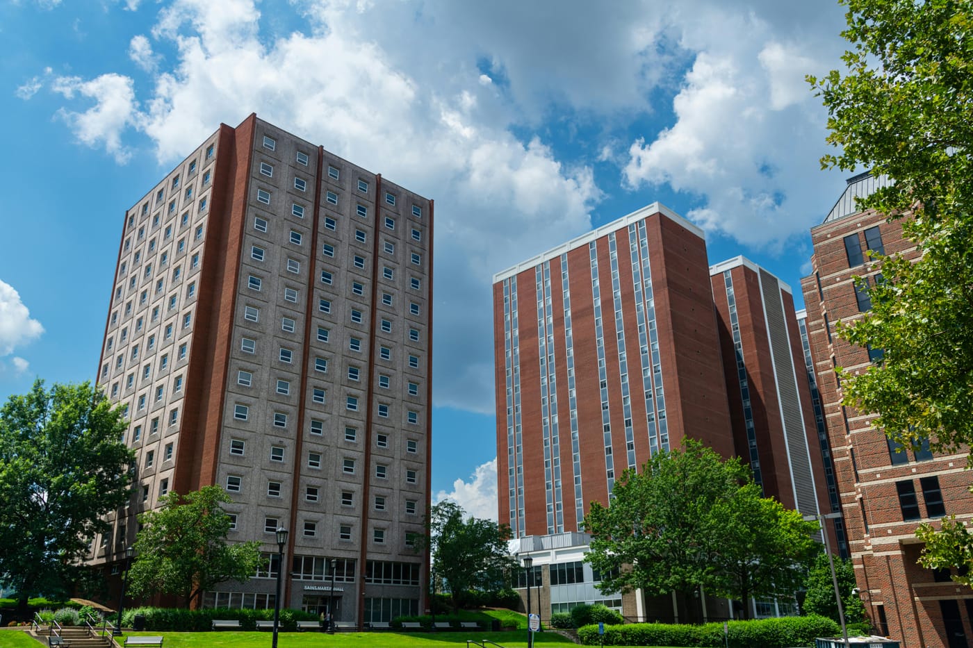 Tall brick apartment blocks with trees in front