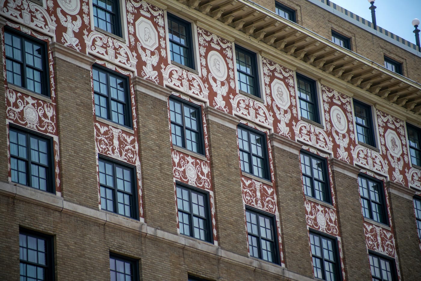 Decorative red brick facade with pale stone patterns