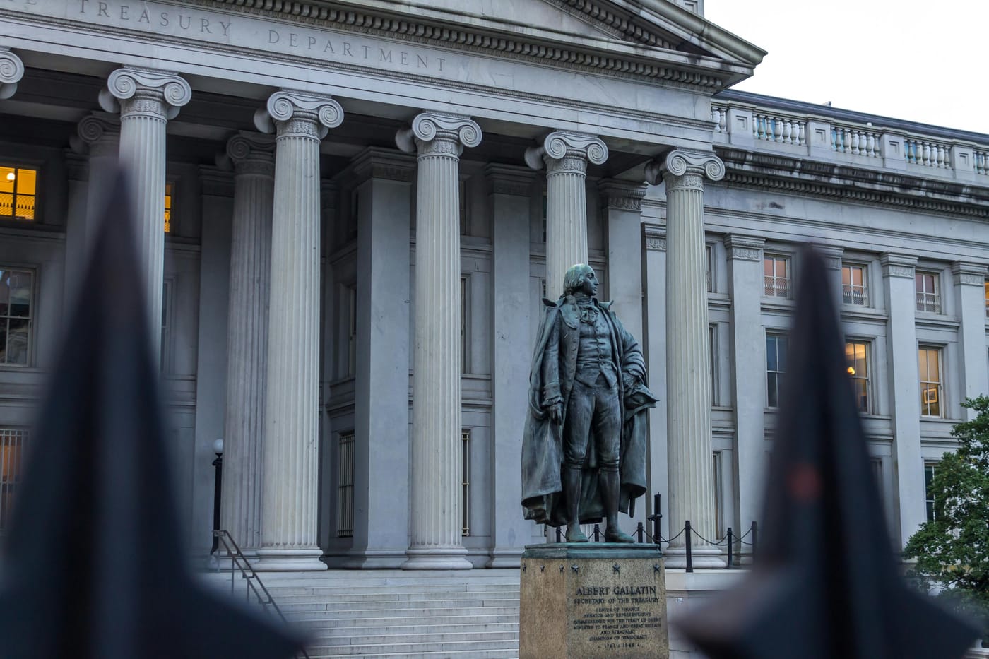 Columned museum facade with a statue in front