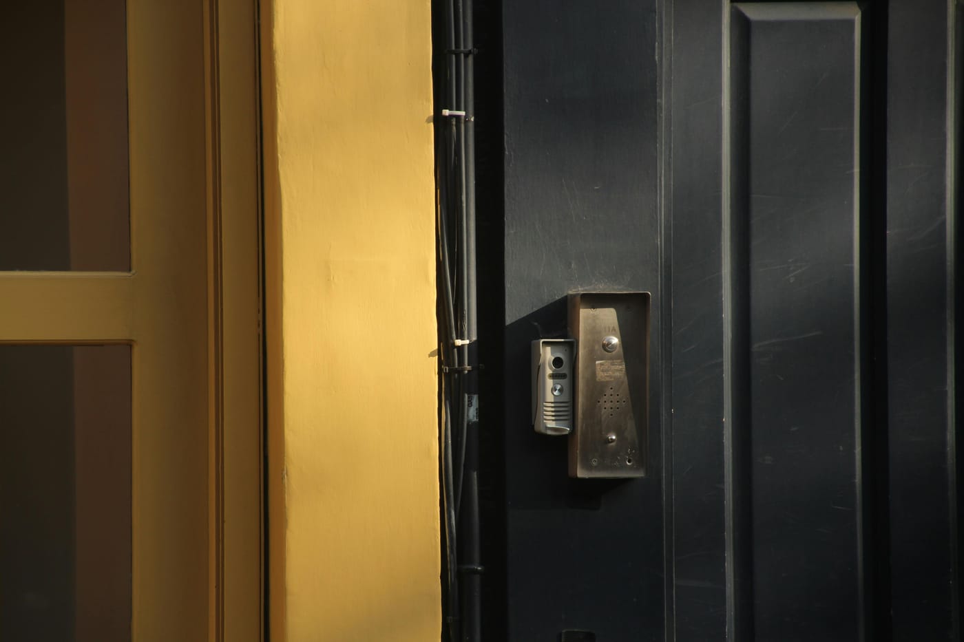 Dark door with a lever handle and electronic reader