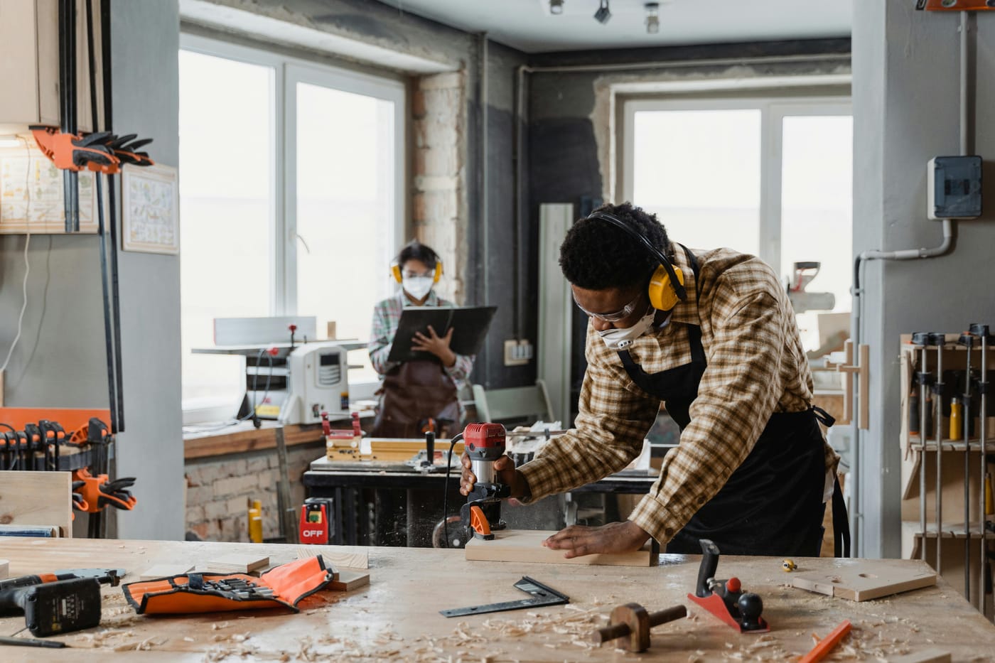 People working at a wooden bench in a workshop