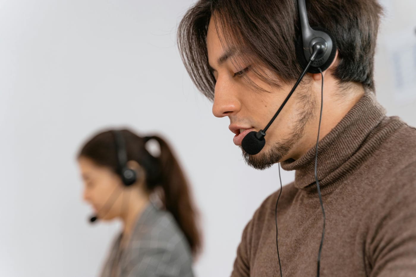 People wearing headsets at a customer-service desk