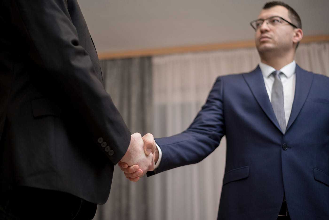 Two people in business clothing shaking hands