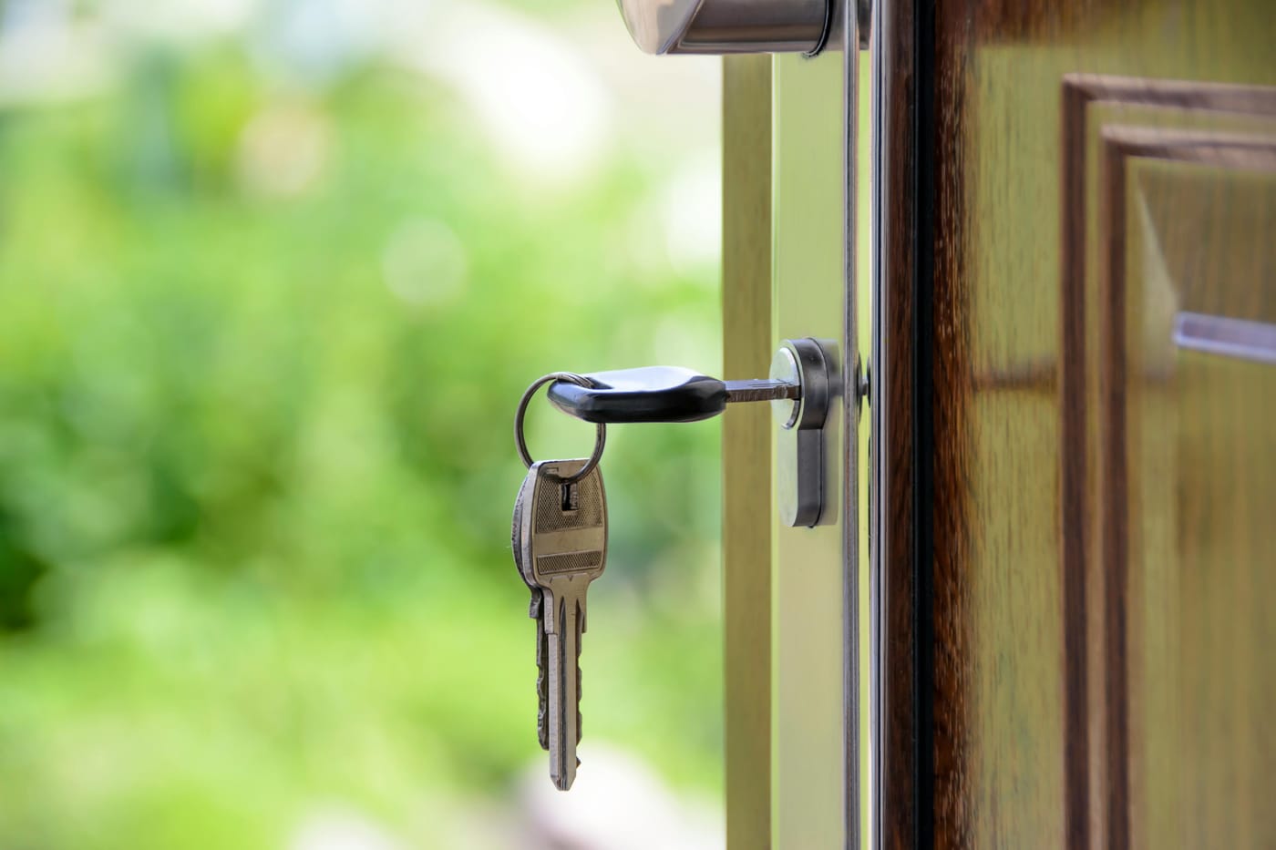 Keys hanging from a lock in an open wooden door