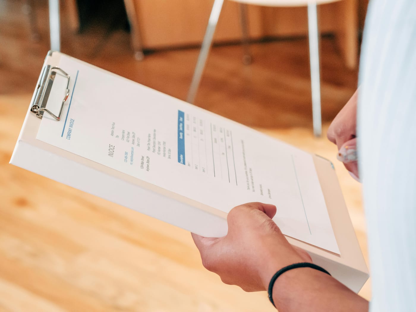 Person holding a clipboard with a printed document