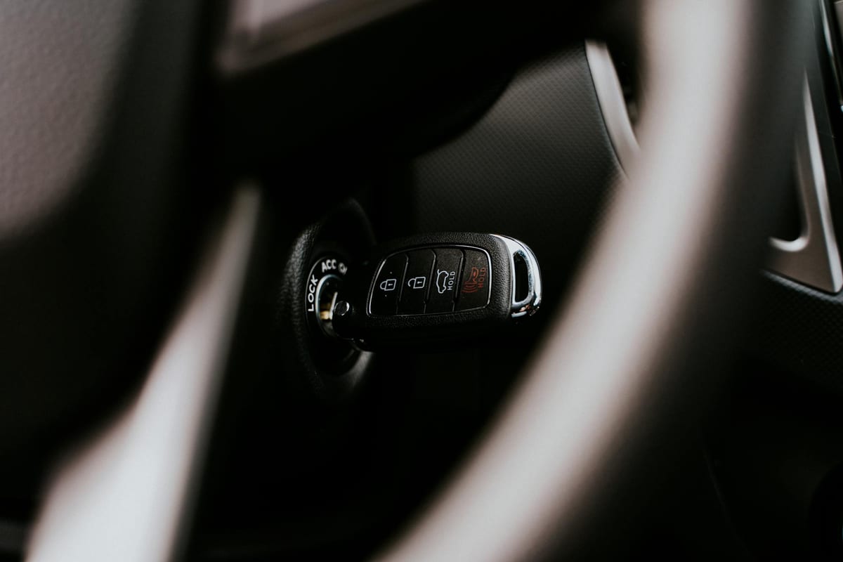Close-up of newly cut car key inserted in vehicle ignition after mobile service
