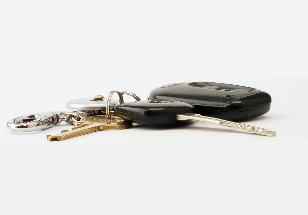 Modern car key fob and transponder key showing chip detail