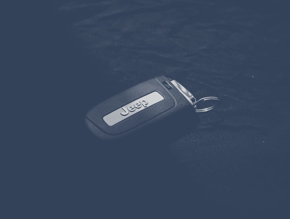 Wireless key fob in dramatic low-key lighting showing keyless entry and transponder functions