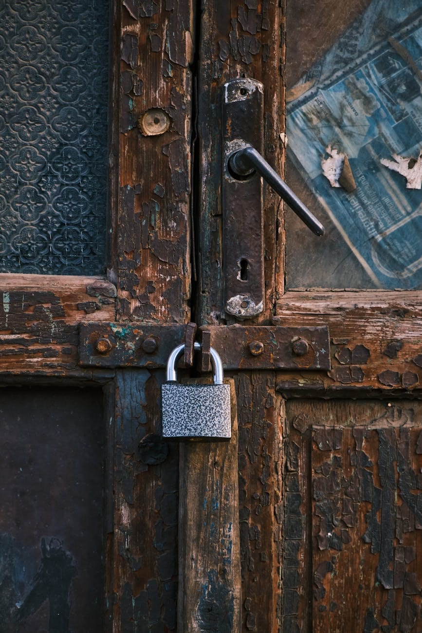 Weathered Capitol Hill rowhouse door with aging padlock before emergency security repair