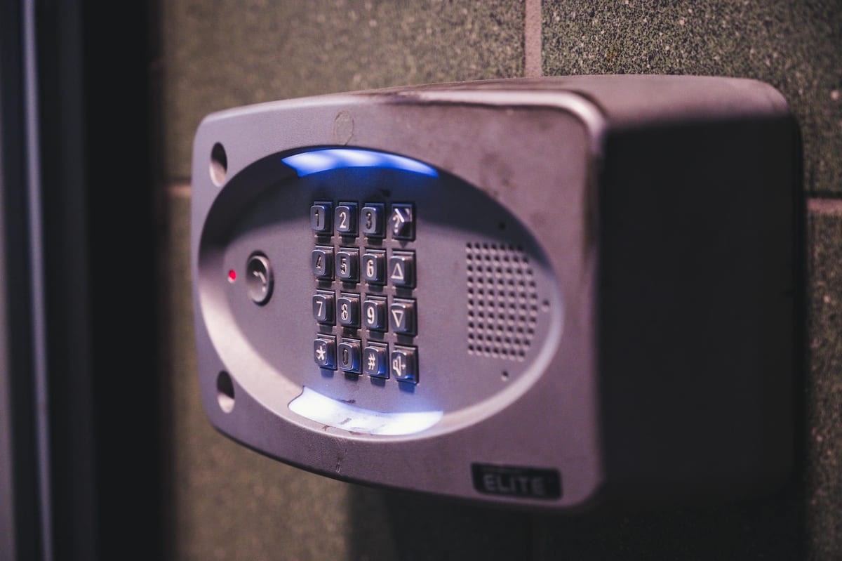 Security alarm keypad mounted on office wall for armed perimeter control