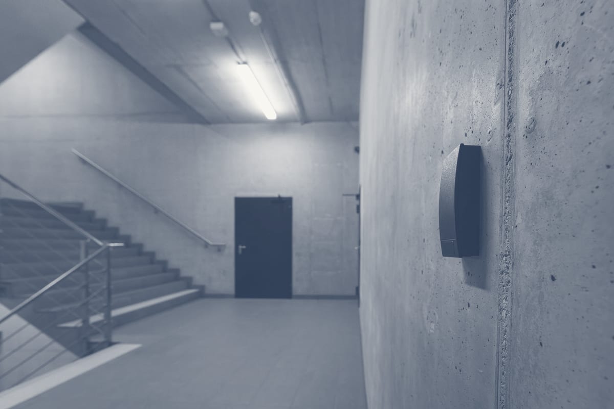 Access control security device mounted in commercial office staircase corridor