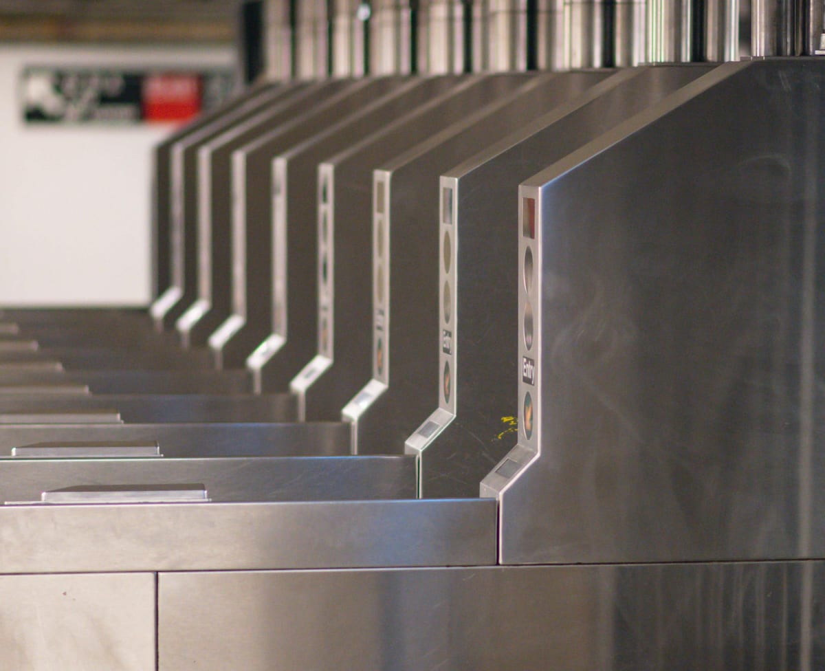 Metal security turnstiles in a commercial building access corridor