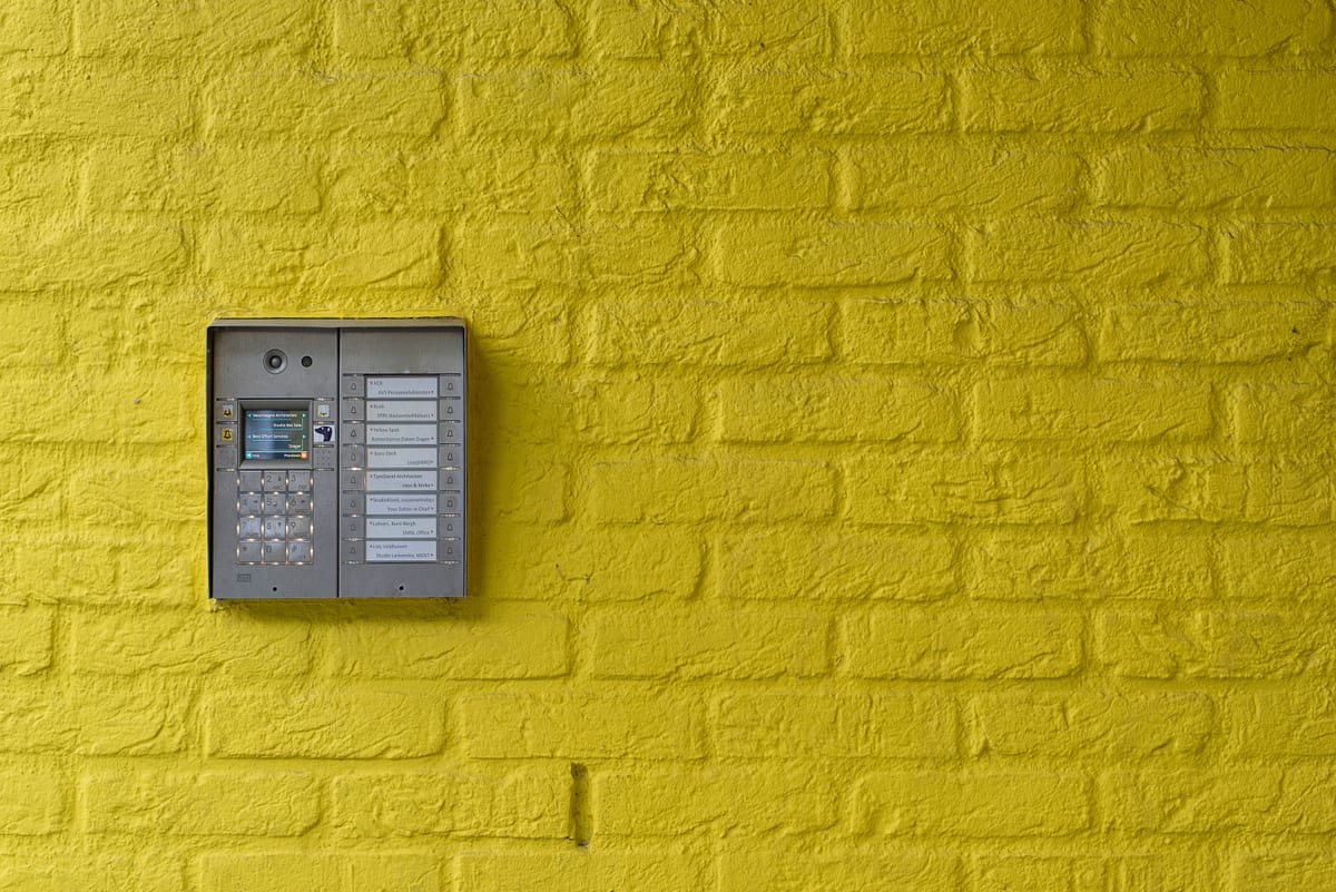 An access control card reader mounted at a commercial building entrance
