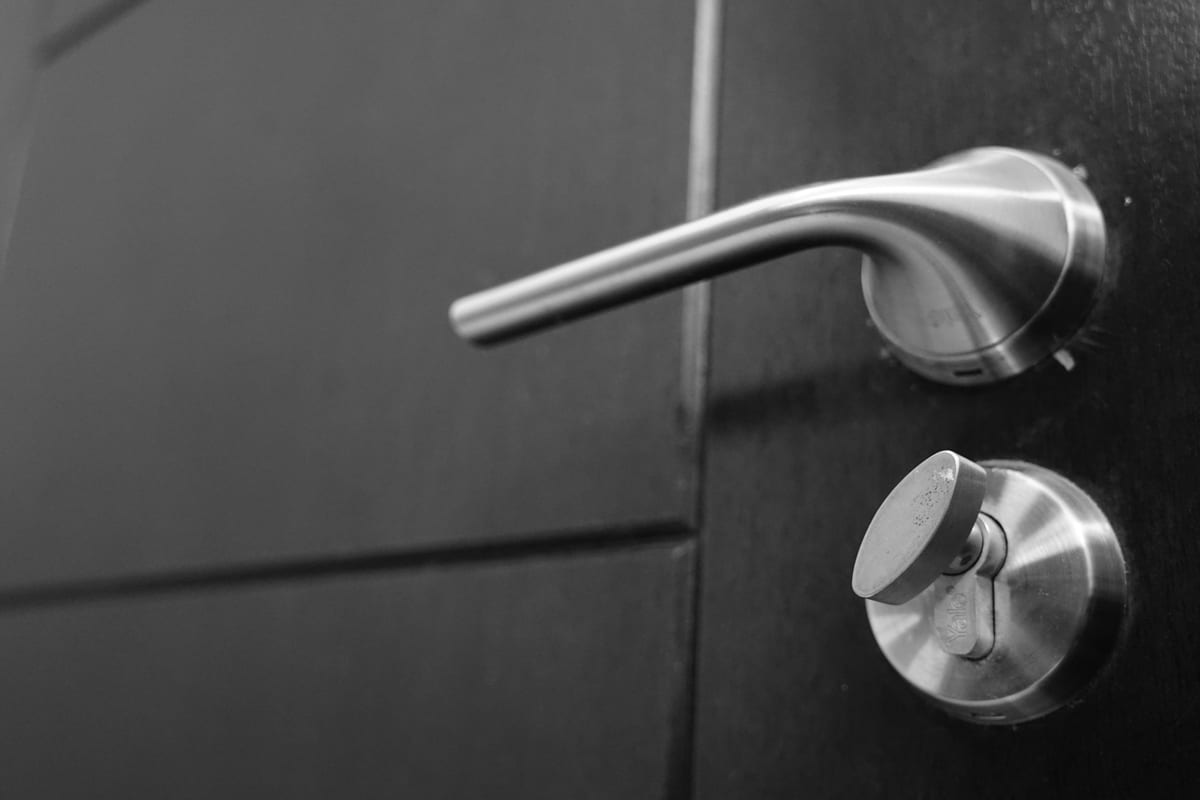 A modern high-security cylinder installed on a historic door