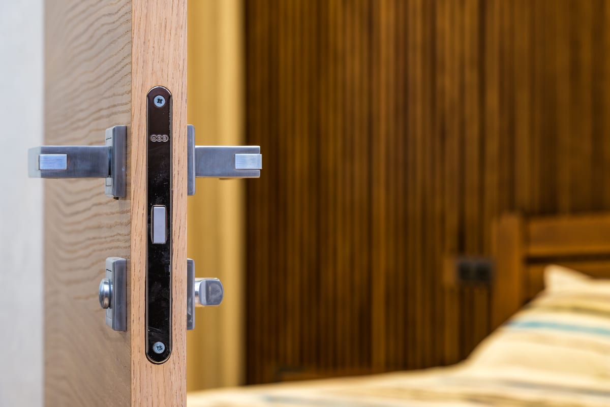 A high-security deadbolt lock being installed on a residential door