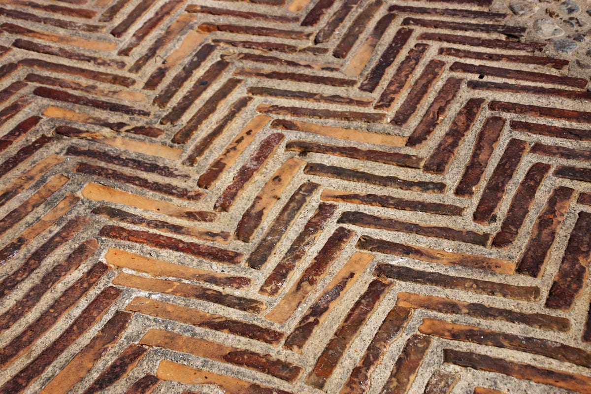 A historic brick sidewalk along an old street