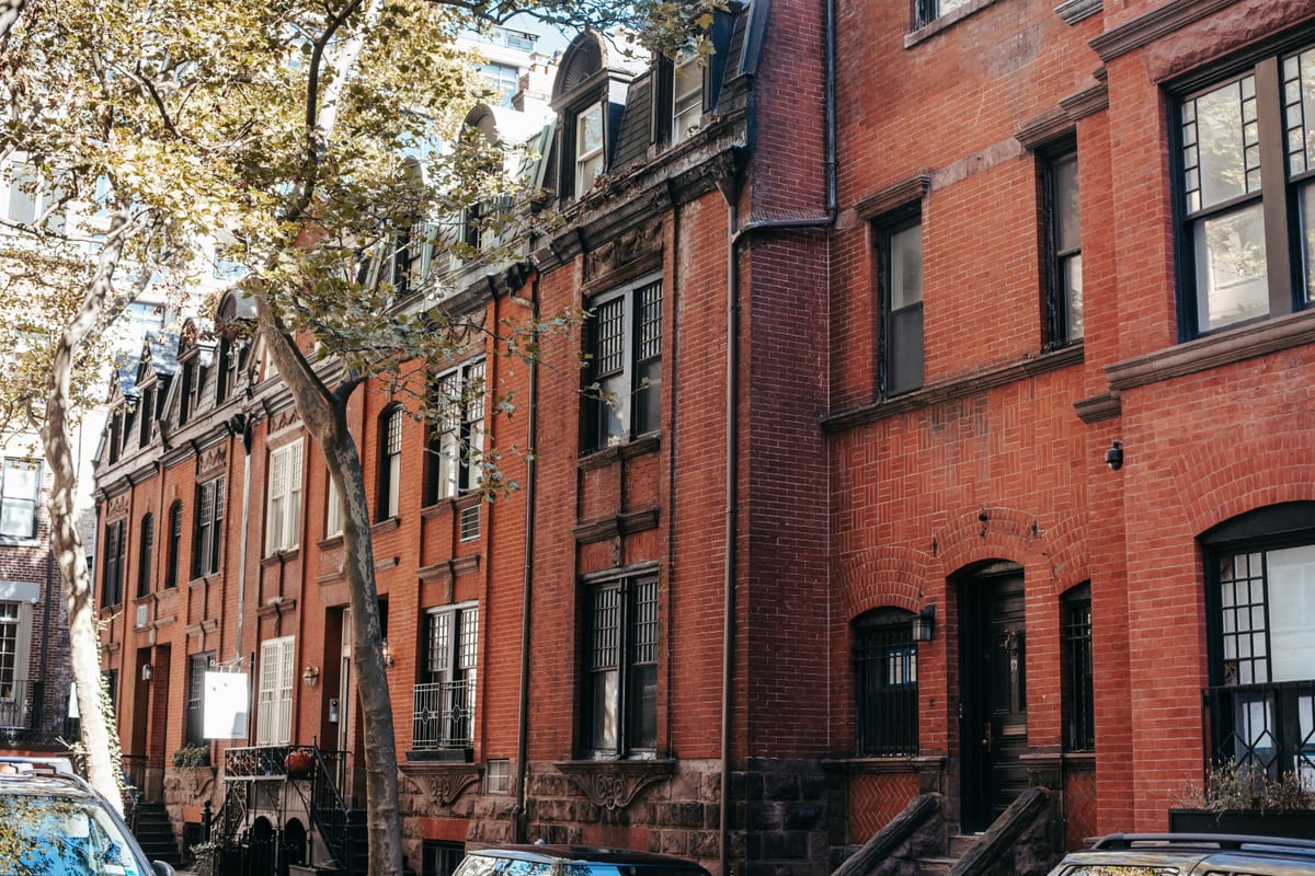 Brick rowhouse facades along a quiet residential street