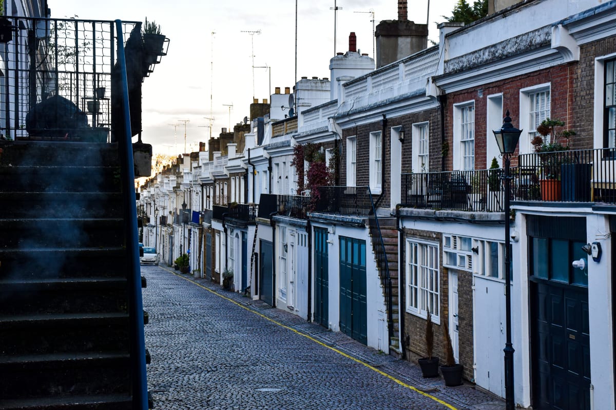 A car parked along a residential rowhouse street