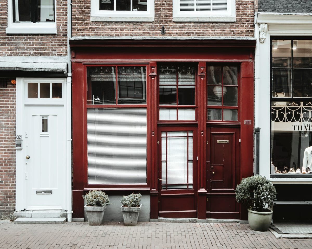 A deep red building facade with classical columns
