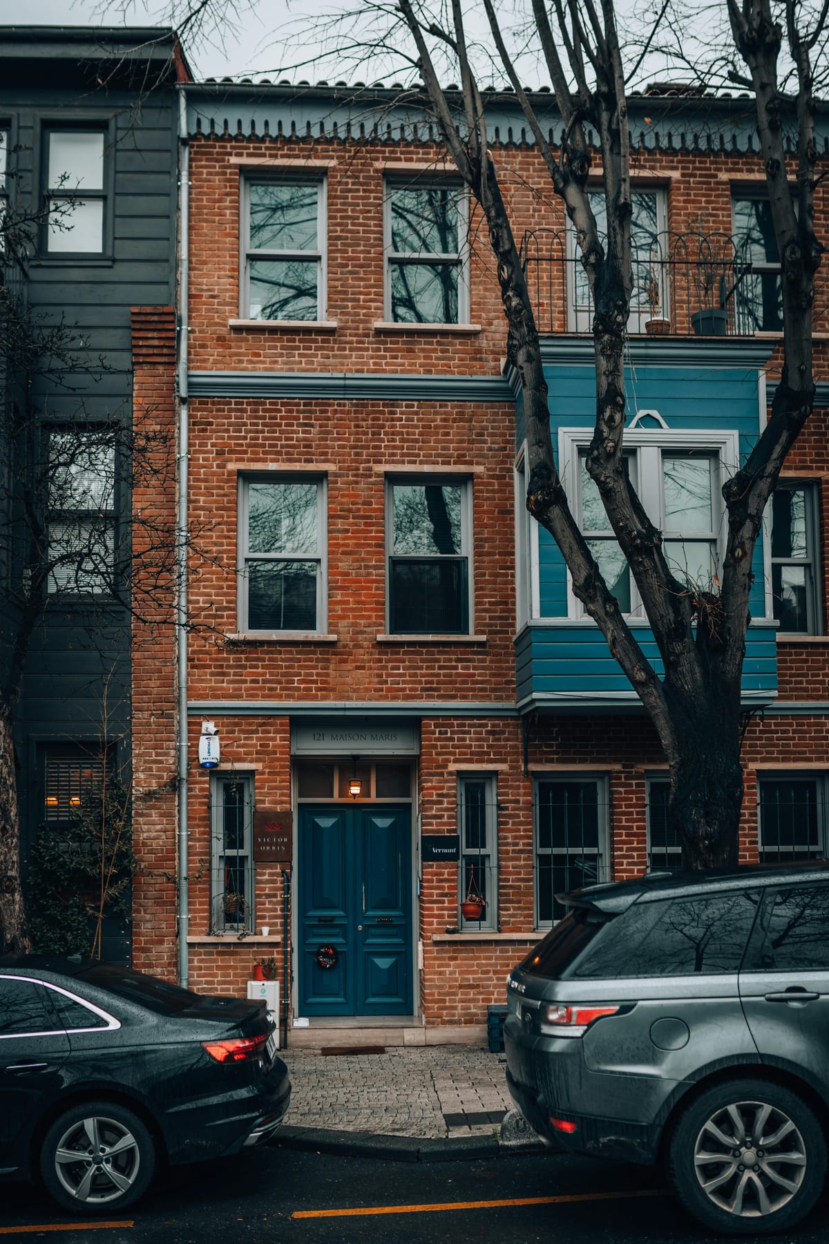 Red brick DC townhouse row with typical residential mailbox placement on urban street