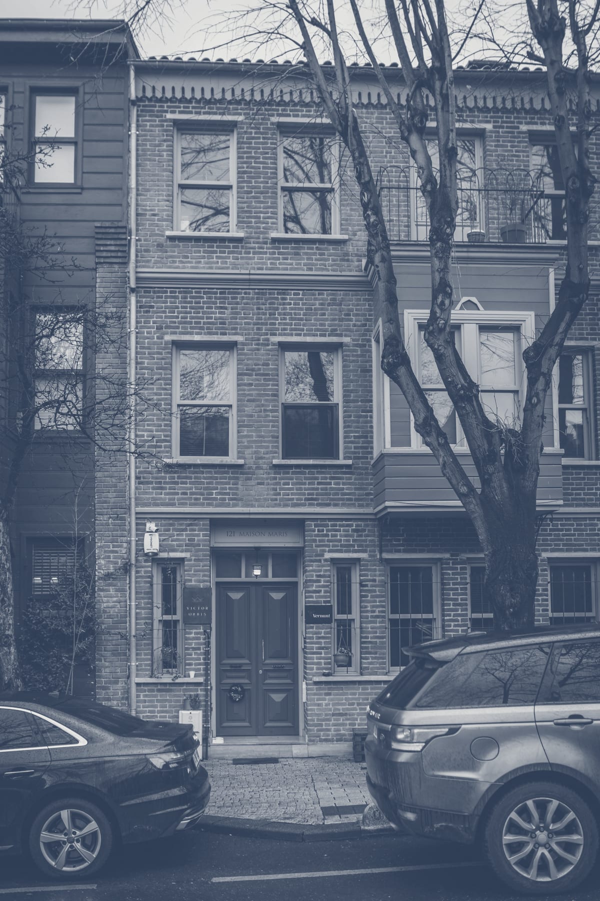 Red brick townhouse with urban residential context in a Washington DC neighborhood