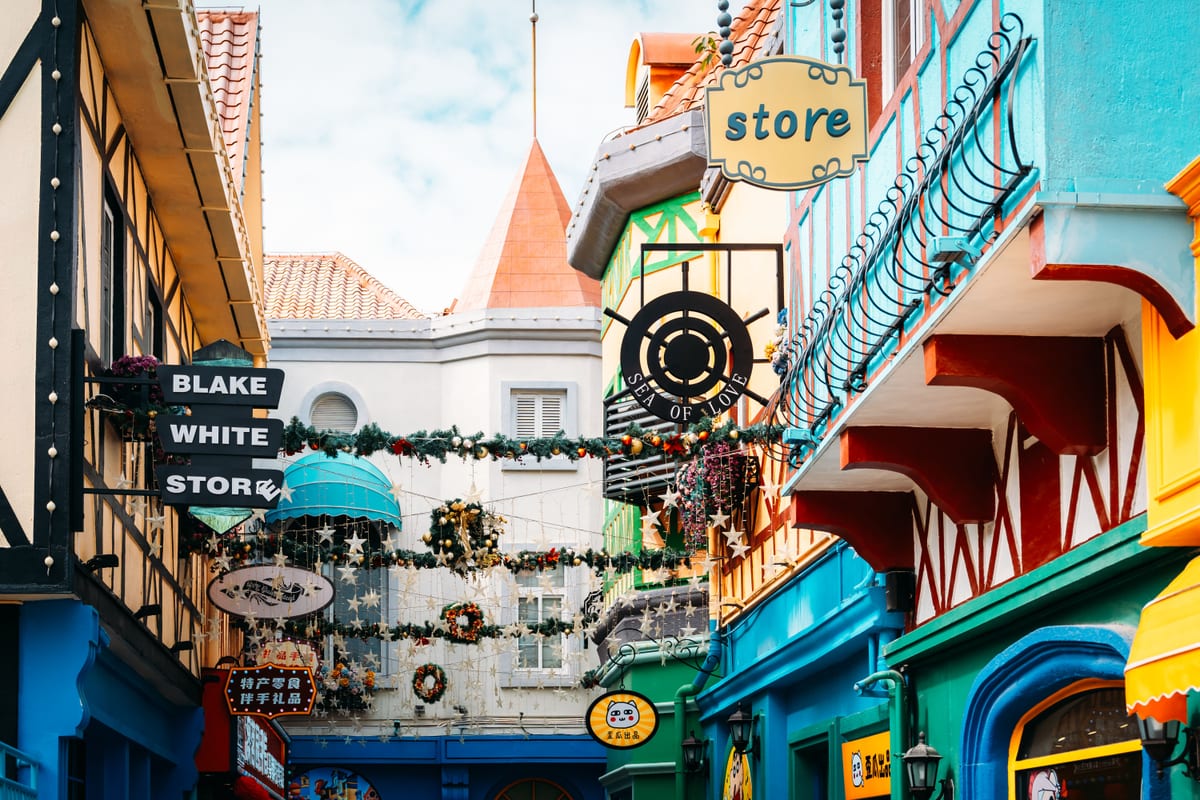 A lively commercial corridor of colorful storefronts