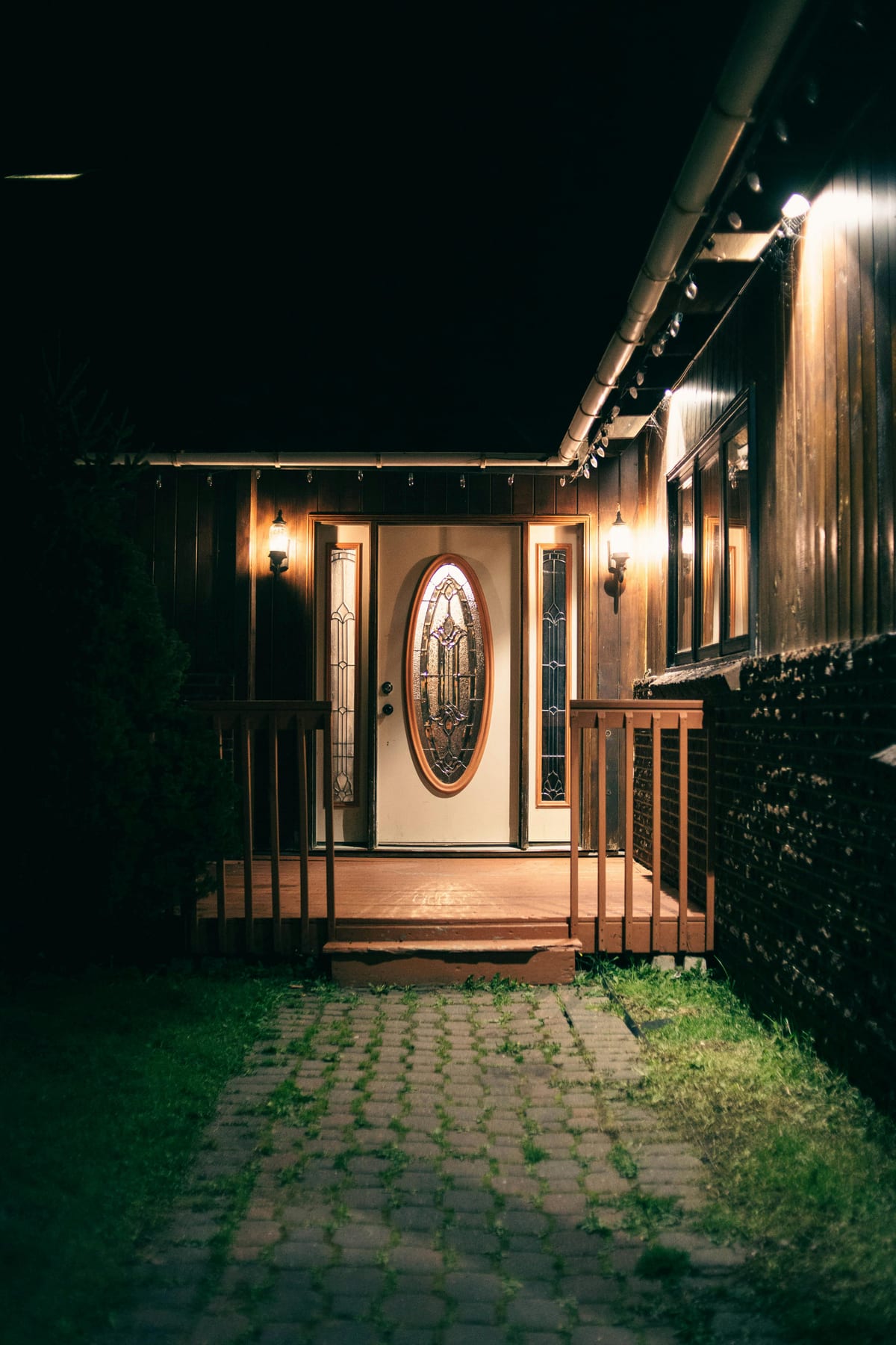 House entrance at night representing an emergency lockout when scammers target homeowners