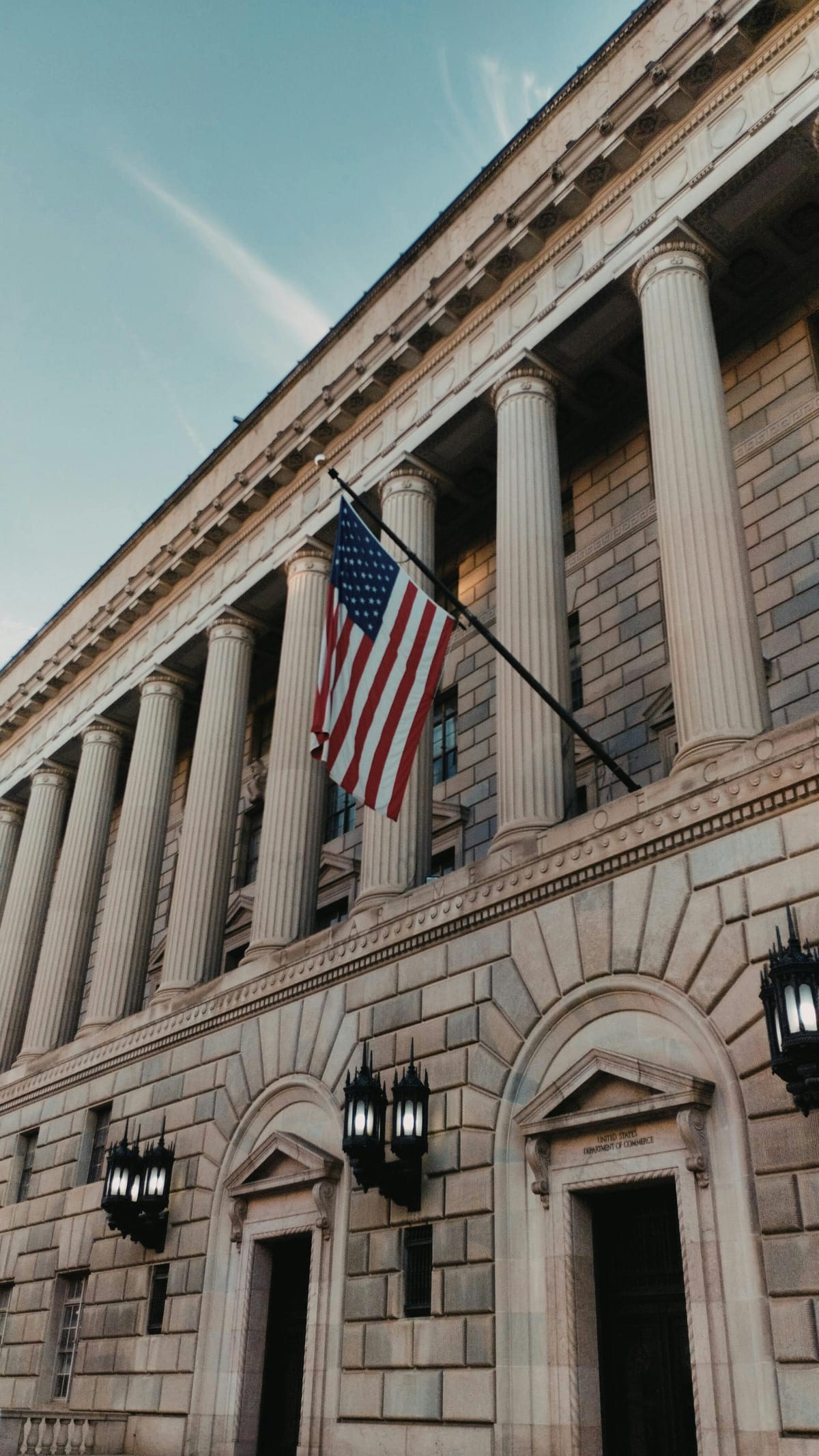Neoclassical Washington DC building with US flag flying above