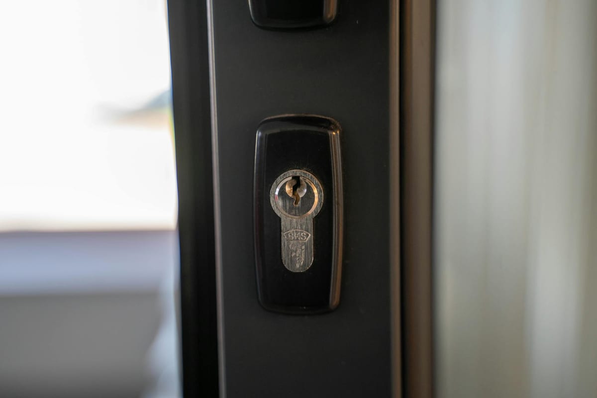 Steel door with high-security keyhole showing a restricted keyway and security deadbolt