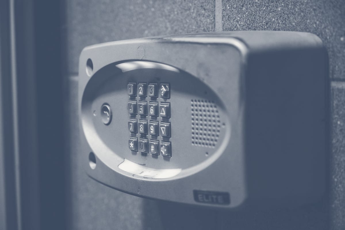 Precision steel keyhole on a door showing restricted keyway preventing unauthorized duplication