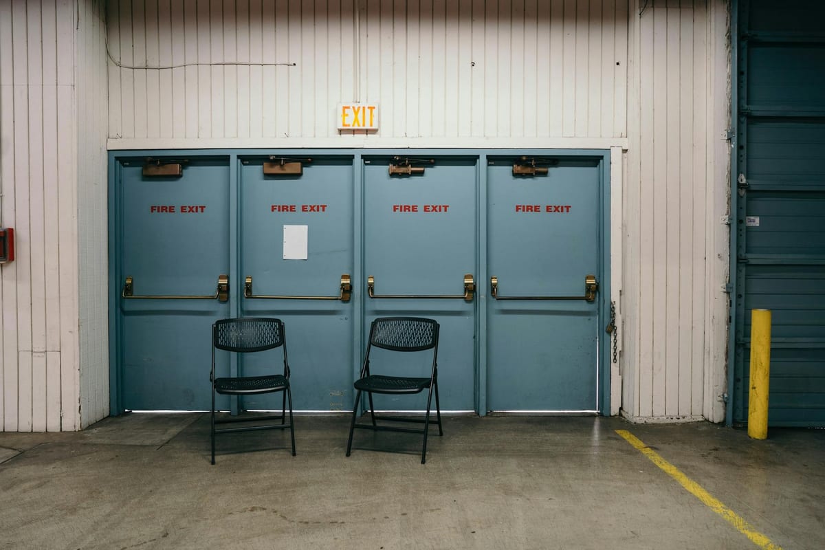 Commercial corridor with fire-rated exit doors equipped with panic hardware